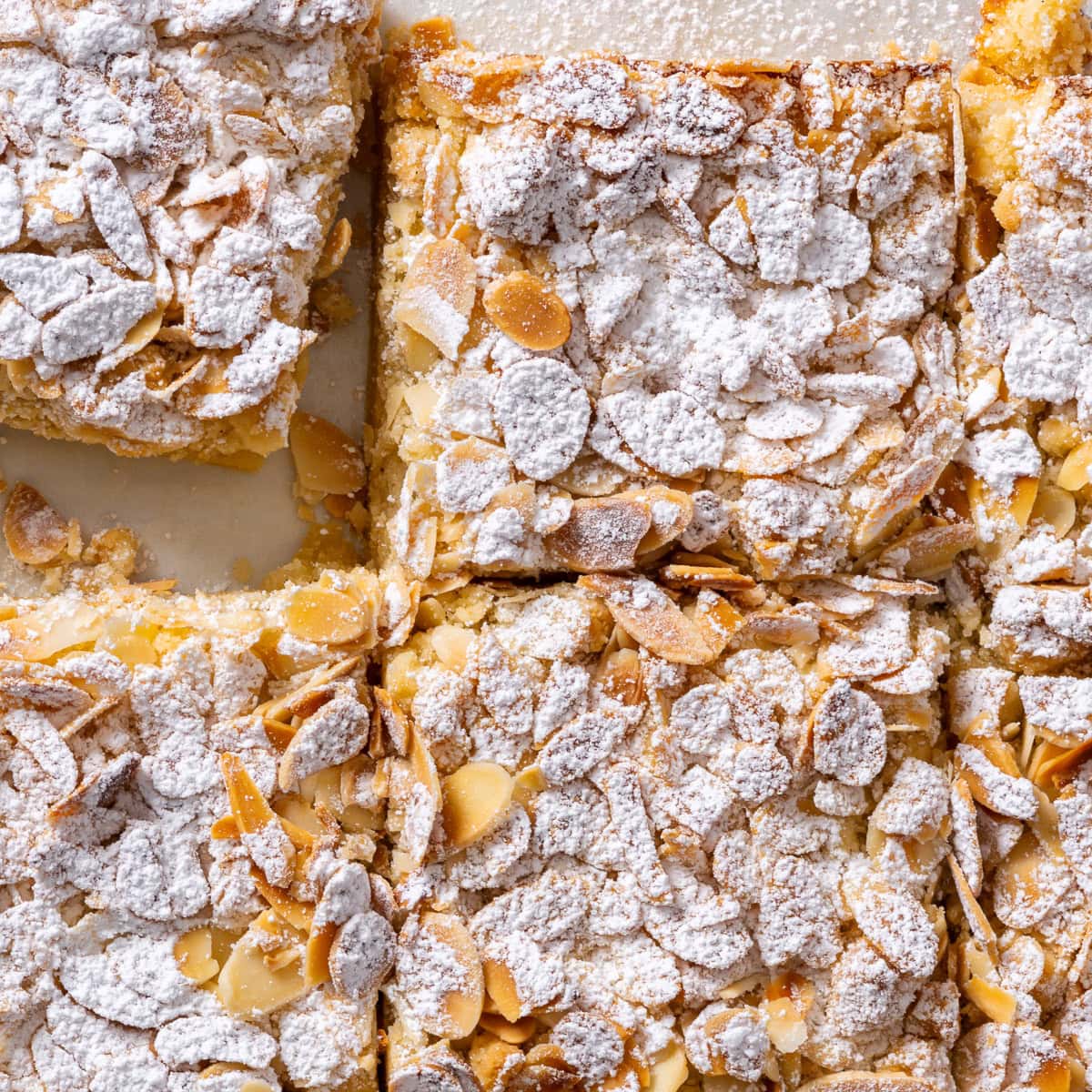 Overhead view of gluten free almond crumble bars, dusted with powdered sugar.